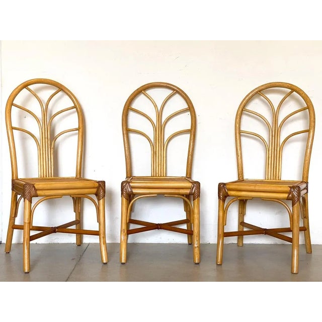 Set of 3 1970s chairs in bamboo and leather bindings.