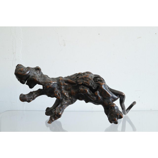 This is an object suggestive of an animal's form, created by retaining the natural bulges and undulations of a wood burl...