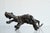 This is an object suggestive of an animal's form, created by retaining the natural bulges and undulations of a wood burl...