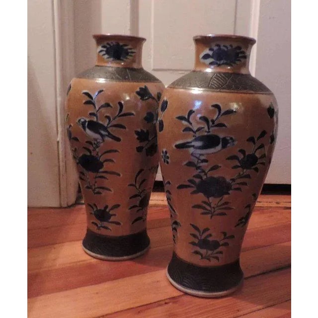 Pair of large 19th c. Chinese export porcelain jars with blue decoration of birds and peonies on a café au lait ground....