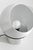 A sculptural aluminum table lamp defined by its spherical shade and open aperture that frames the exposed bulb within. The...