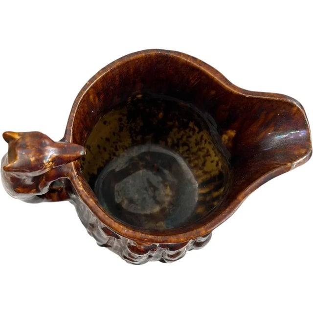 This vintage Rockingham clay molded pitcher with a hound handle is a great addition to your collection. The pitcher...