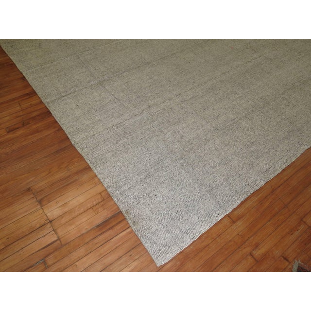 Plain solid gray one of a kind Turkish Kilim with small specs in black. 10' x 14'1''
