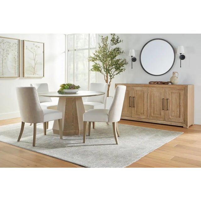 Introducing Coulter's 54" Round Dining Table, adorned with a starburst pattern pedestal base and an elegant angled edge....