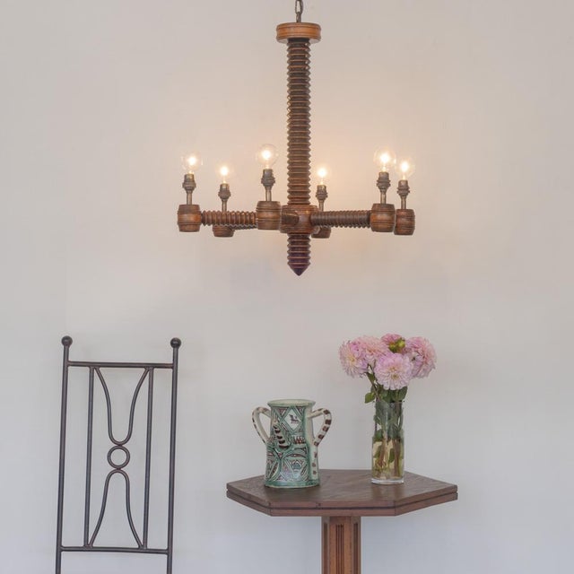 Incredible carved wood chandelier by Charles Dudouyt from France, 1940s. Chandelier with six intricately carved wood arms....
