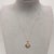 A refined 18ct yellow gold pendant showcasing a 1.97ct opal with shimmering flashes of green and ember. Its cushion‑shaped...