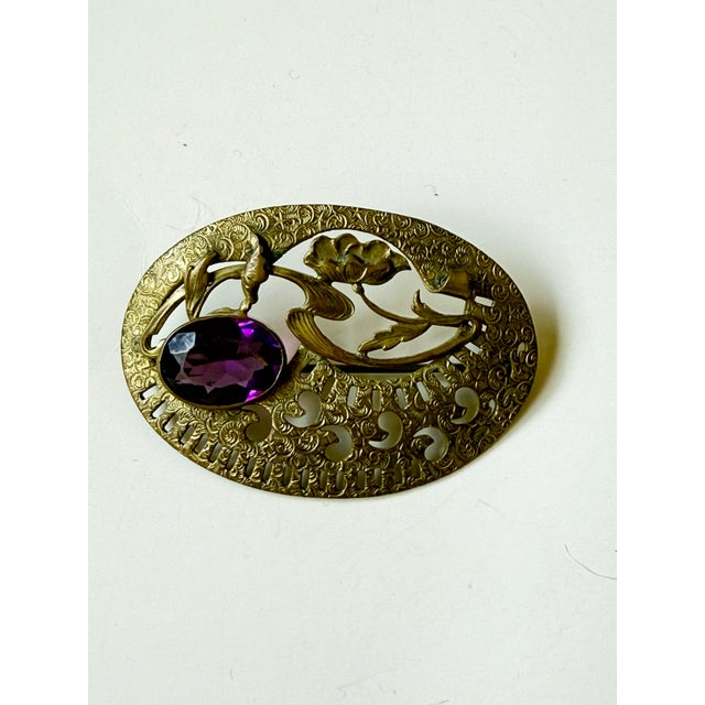 Lovely antique Art nouveau sash pin with purple cut crystal or glass stone. Iconic art nouveau floral design with lotus...