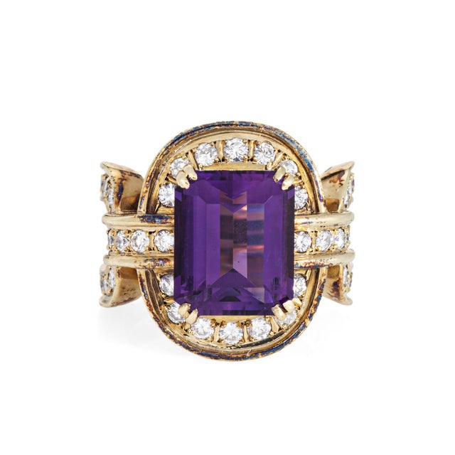 Stylish amethyst & diamond wide band (circa 1980s) crafted in 14 karat yellow gold. Emerald cut amethyst measures 12mm x...