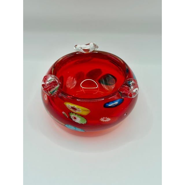 Please read the entire description. A vibrant vintage hand blown art glass ashtray with a rich translucent red body,...