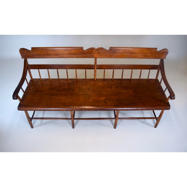 An American 19th century Pennsylvania pine & poplar Windsor bench with half spindles and single board plank seat. At...