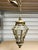 This Louis XIV style lantern pendant was made in the Early 20th Century. It consists of a beautifully crafted brass frame...