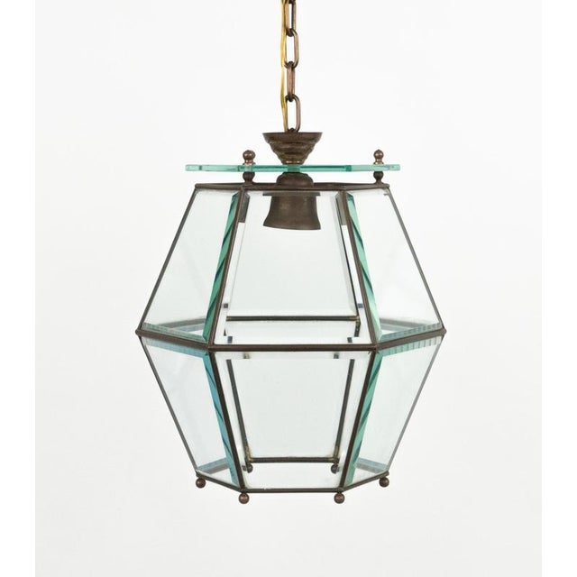 Midcentury amazing chandelier lantern in brass and beveled glass in the style of Adolf Loos. Made in Italy in the 1950s....