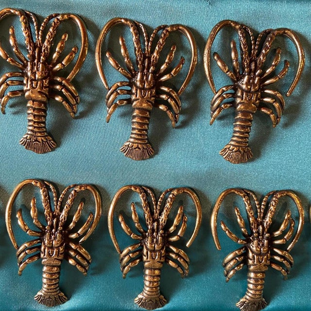 Set of 12 incredible bronze lobster knife rests. Case exterior shows signs of wear.