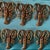 Set of 12 incredible bronze lobster knife rests. Case exterior shows signs of wear.