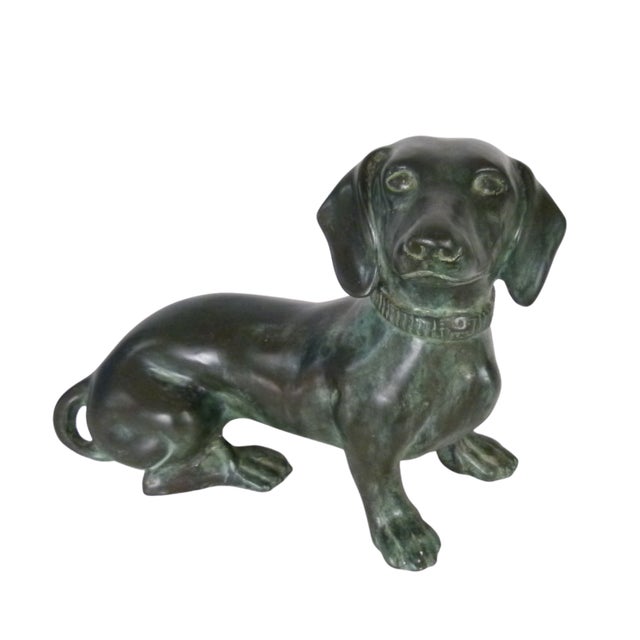 A heavy, high-quality mid-century vintage solid cast bronze Dachshund sculpture. Weighing in at 10 pounds, this piece...