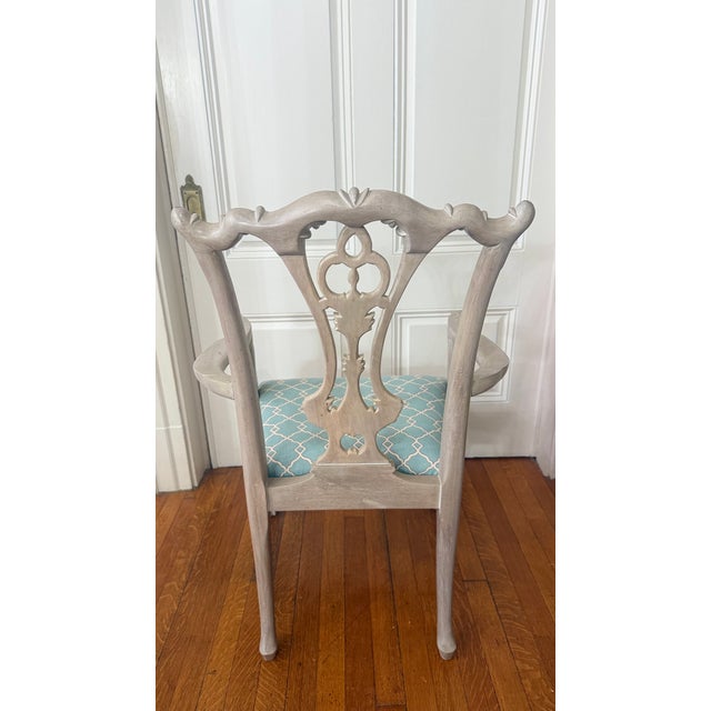 This elegant pair of carved armchairs by Paramount Antiques of New York showcases the timeless sophistication of...