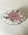 A wonderful shaped mid-century floral box with a background of pale, pink and pink and green flowers.