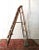 This folding wooden painter's ladder dates back to the 1960s. The folded height is 205 cm and the unfolded depth is 115 cm.