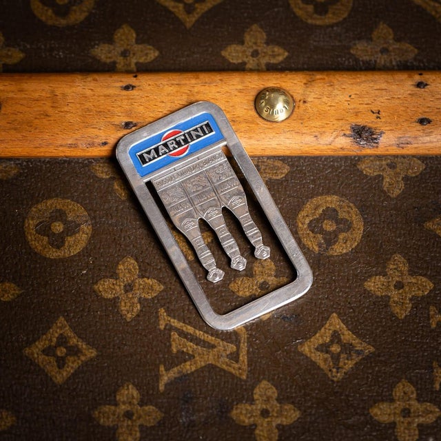 Vintage 20th century english solid silver bookmark. It features an engraved martini logo, highlighted in enamel with the...