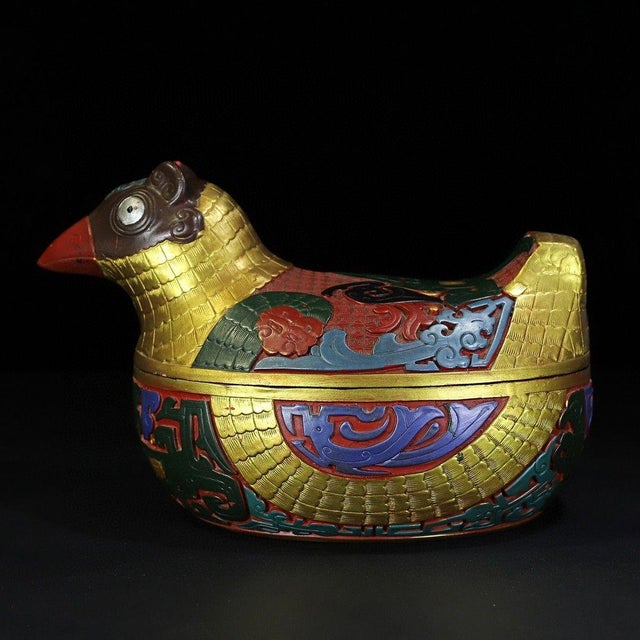 This striking antique lacquerware box is finely modeled in the form of a crested eagle or bird, a traditional symbol of...