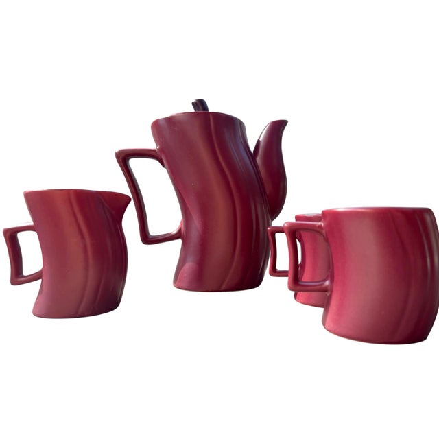 A striking vintage Royal Orchid Stoneware coffee service in a rich burgundy/wine glaze, featuring a sculptural ribbed form...