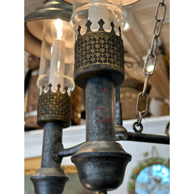 Handsome vintage metal tole multi arm chandelier having downward advice metal bell shaped shades. Dark patina with chain...
