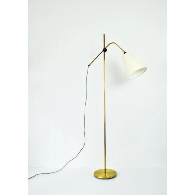 Modern Brass Floor Lamp with adjustable arm and head, 1970s. Mounted with a new shade. Measures: Lamp base diameter 22.5...