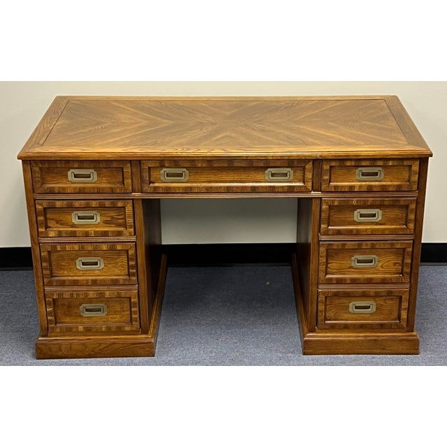 Very nice well cared for vintage campaign style desk. Double pedestal design with a total of 7 drawers. The center drawer...