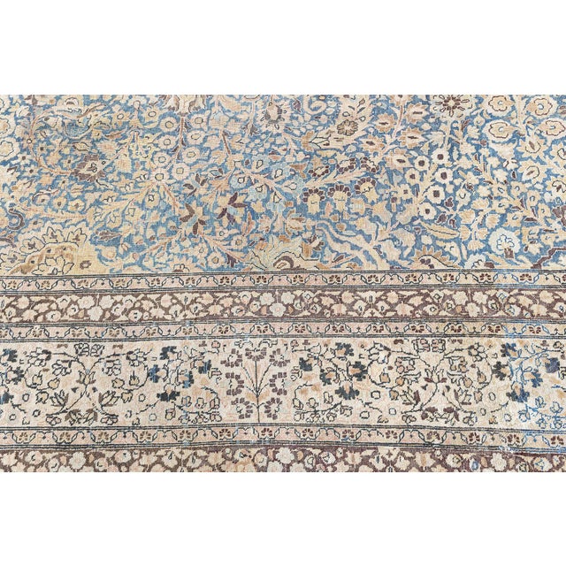 A decorative early 20th century Persian Meshad (Meshed) antique rug, the light blue field with a dense overall design with...