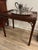 This antique table was made during the Victorian era in England (183I 7-1901). It is a reproduction of an original...