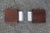 A pair of door handles from the 1960s made of geometric teak elements mounted on curved aluminum hardware. They have a...