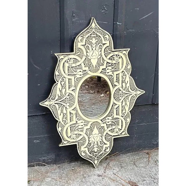 1960s-70s Piero Fornasetti style gothic printed medallion-shaped wall mirror. One bumped corner at top where material is...