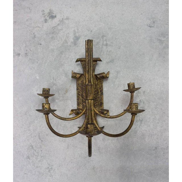 A striking pair of Spanish gilt metal wall sconces dating from the 1950s. Handcrafted with a richly textured gilt finish,...