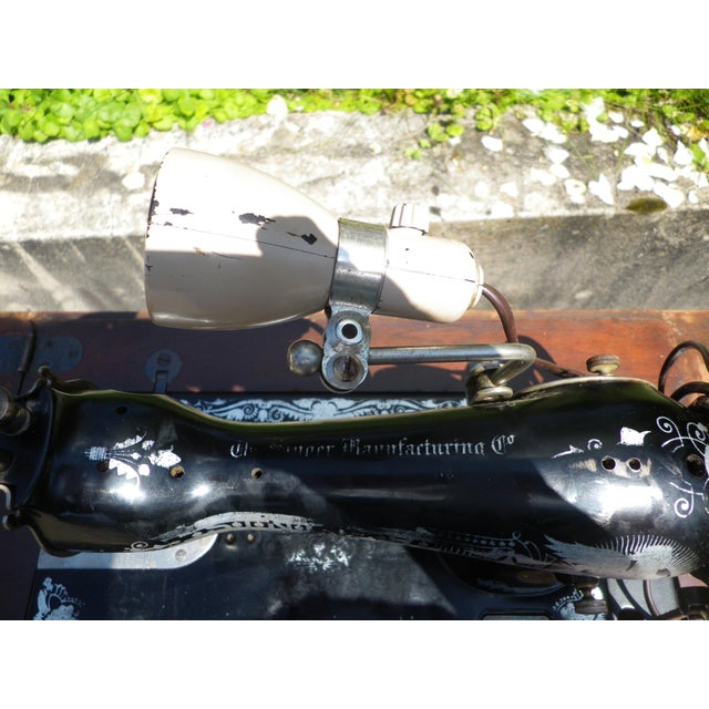 Made in Scotland in September 1928, reference number y6153113, model 15k. Singer sewing machine with Egyptian-inspired...