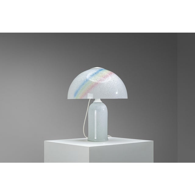 A strikingly large table lamp by Doria Leuchten, sculpted entirely from luminous bubble glass. The substantial glass base...