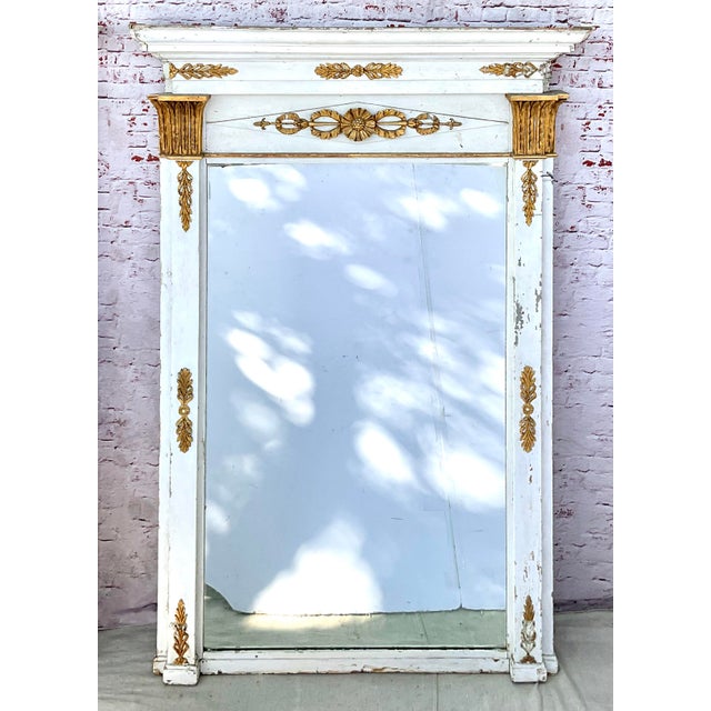 French Neoclassical White Painted and Parcel Gilt Pier Mirrors. A rare pair of early 19th century French grand-scale...