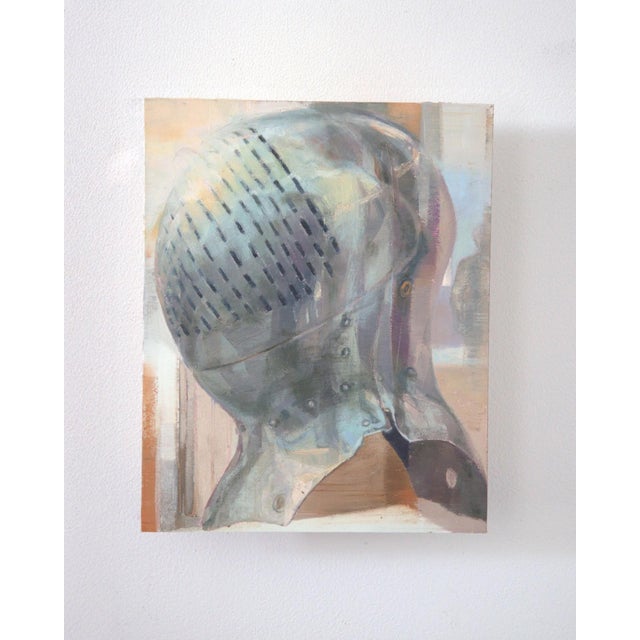 This oil on panel work presents a close-up view of a reflective helmet, its smooth surface capturing light and creating a...