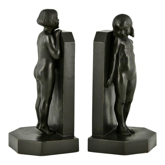 A rare and highly decorative pair of Art Deco bronze bookends with children titled “Simplicity”, designed by Raoul Benard...