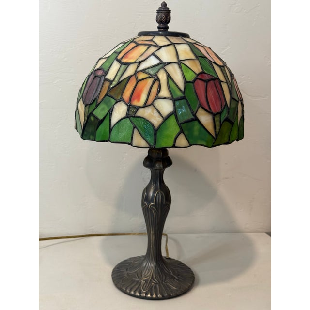This stunning 22-inch Tiffany-style table lamp features a meticulously handcrafted 12-inch stained glass shade with a...