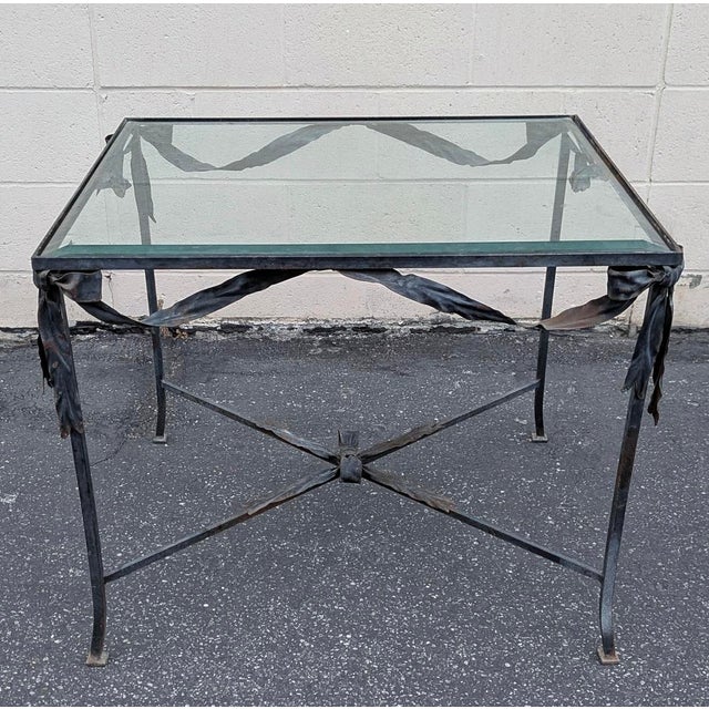 Elegant and sculptural, this vintage wrought iron and glass center table embodies the timeless sophistication of French...