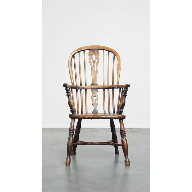 Offered is this beautiful and practical antique English highback Windsor chair with a beautiful patina. This beautiful...