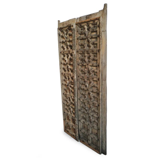 Original hand carved smaller scale doors from North India. Traditional design with pattern and iron rivet details.