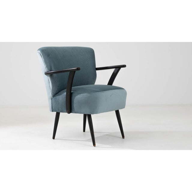 This 20th Century Danish upholstered armchair is a celebration of minimalist design and comfort. Enveloped in a plush,...