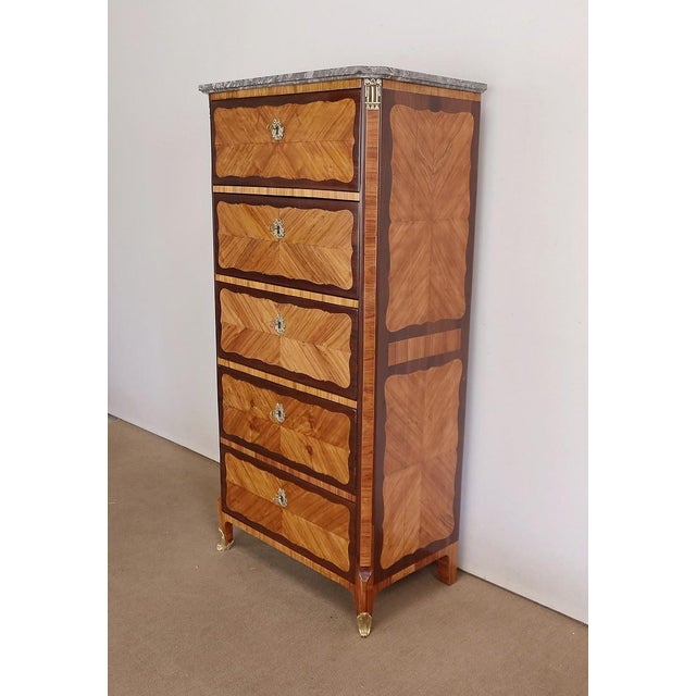 Large chiffonier of the 18th century, in marquetry topped by an original Saint-Anne marble. This refined piece of...