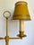 Here is a vintage mid-20th century bouillotte-style table lamp featuring a fantastic mustard-yellow finish and decorative...