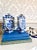 A striking pair of blue and white porcelain five-spout vases, hand-painted with dynamic dragons chasing the flaming...