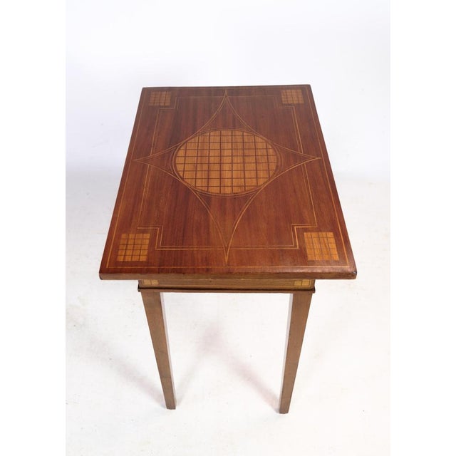 Mahogany side table with decoration in the form of walnut marquetry on both table top and legs from around the 1920s....