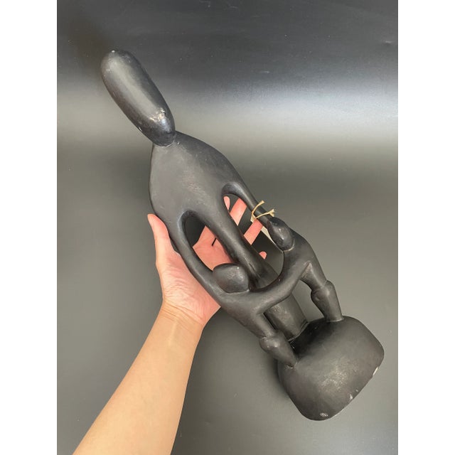 An abstract Ghanaian family circle wood sculpture. Hand carved by local artisan from a single piece of wood. Nice...