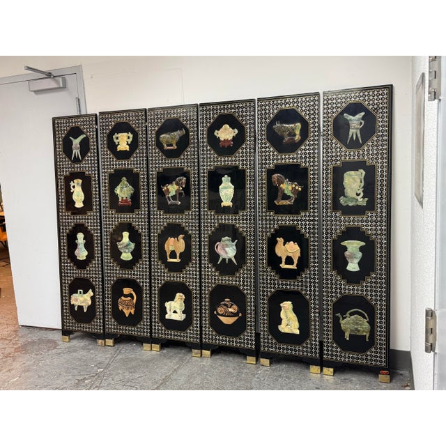Design Plus Gallery presents a Chinese Mother-of-Pearl “Hundred Antiques” Screen. This six-panel folding screen has a...