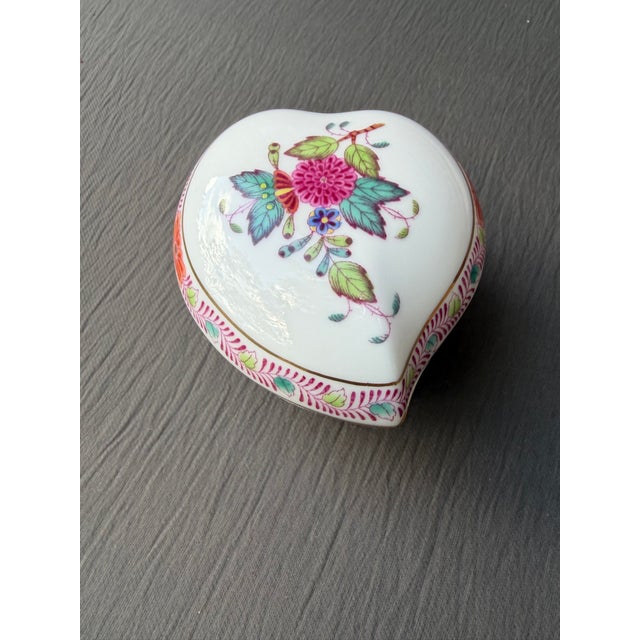 Small vintage hand painted floral, stylized porcelain heart trinket box. Delicate gold gilt accents. Made by Herend, in...